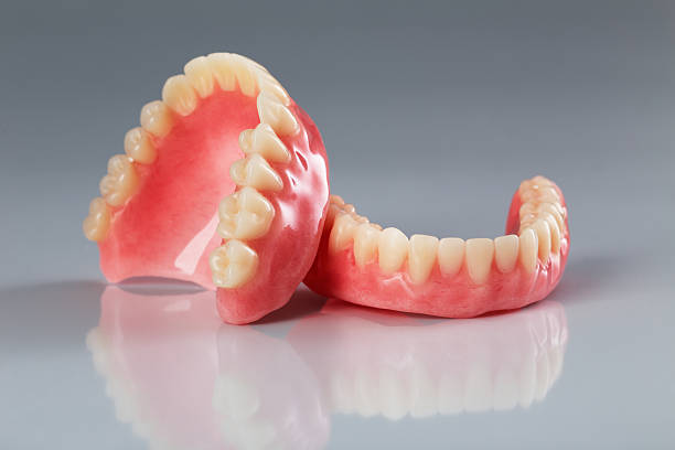 DrDalmao-A set of dentures on a shiny gray background